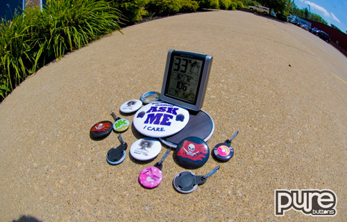 Assorted Custom Buttons on a hot sidewalk
