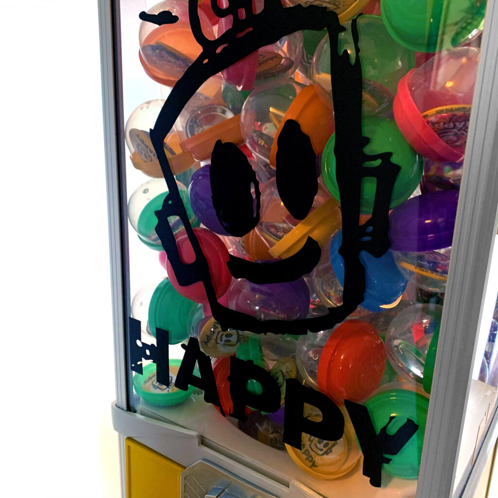 Closeup of HAPPY button vending machine