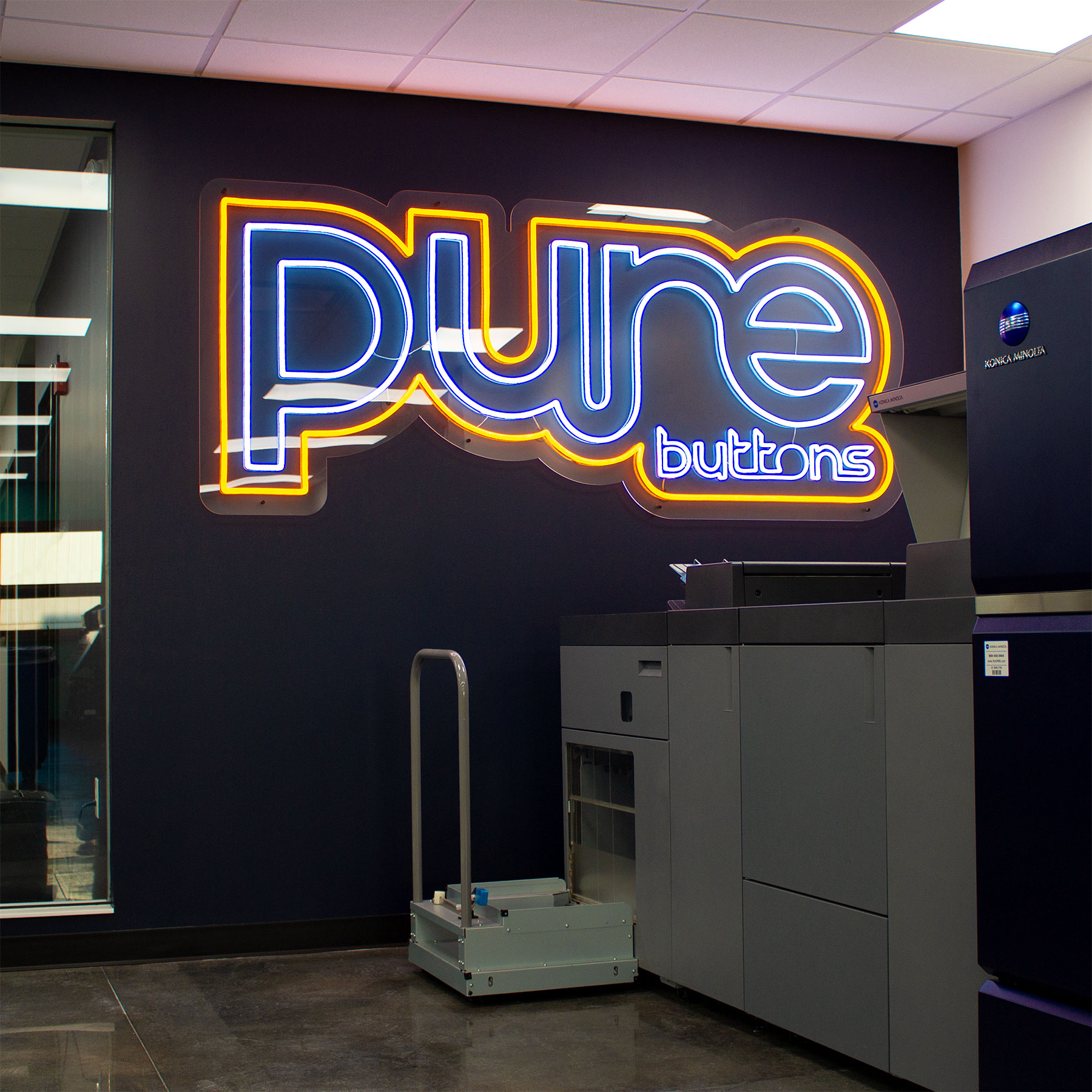 Pure Buttons Neon Sign in the Custom Button Printing Room