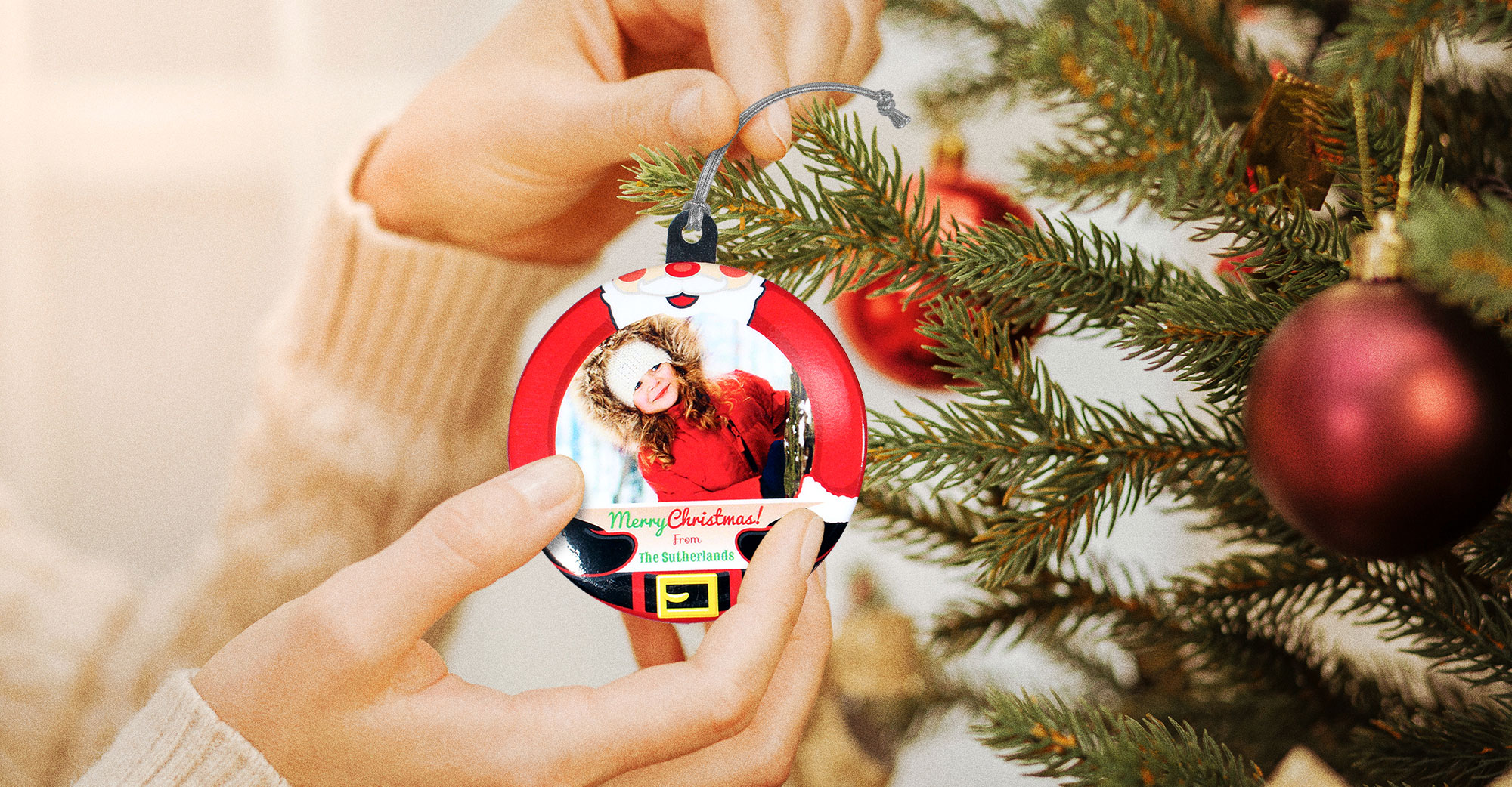 Hanging a personalized photo ornament on the christmas tree