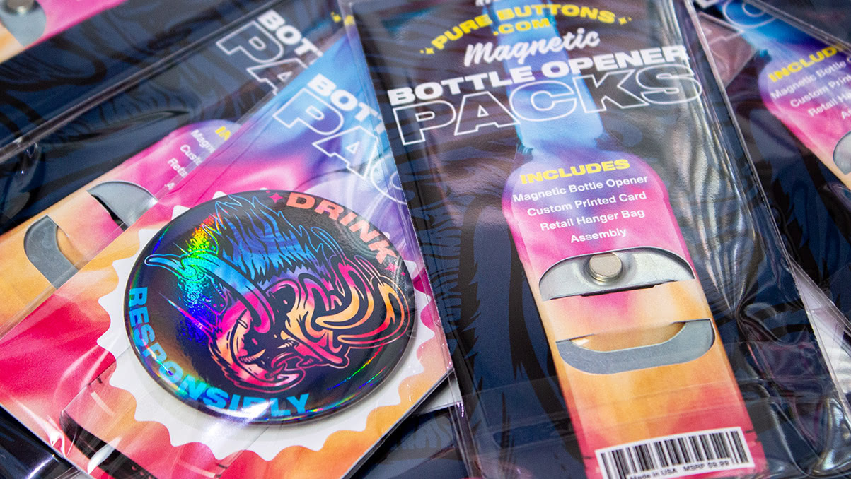 Closeup of the back side of magnetic bottle opener retail packaging, showing neodymium magnet and all-metal construction.