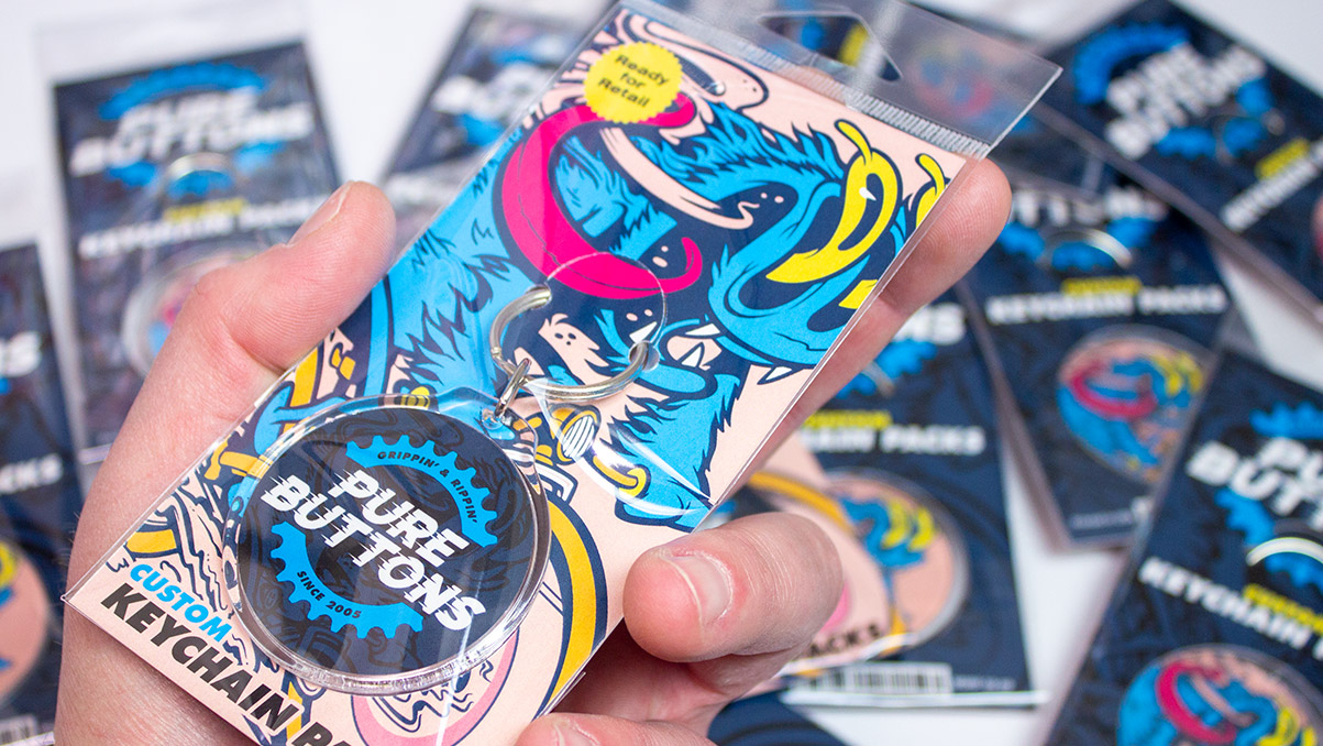 A Hand Holding Our Custom Round Keychain Retail Packaging