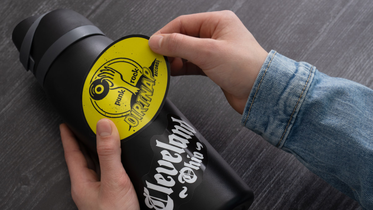 Applying glossy stickers to a waterbottle